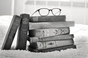 black and white image of a stack of old books