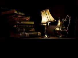 old books stacked under tungsten lamp
